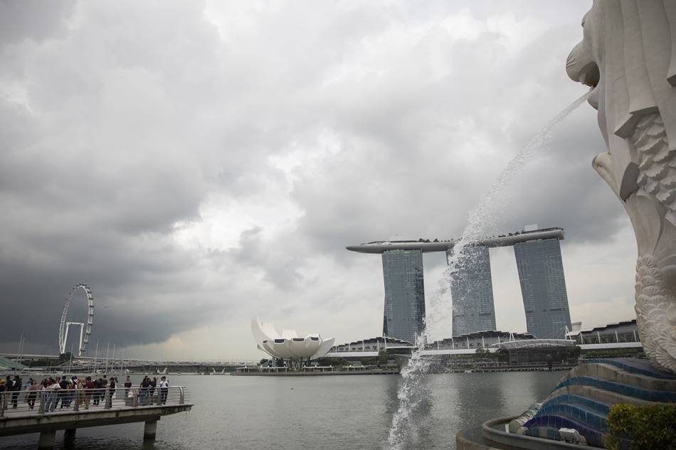 People visit the Merlion Park in Singapore, Dec. 2, 2022. Singapore has tied with New York as the world's most expensive cities, according to the Worldwide Cost of Living 2022 survey by London-based Economist Intelligence Unit (EIU) released on Dec. 1. How Hwee Young, EPA-EFE/File 