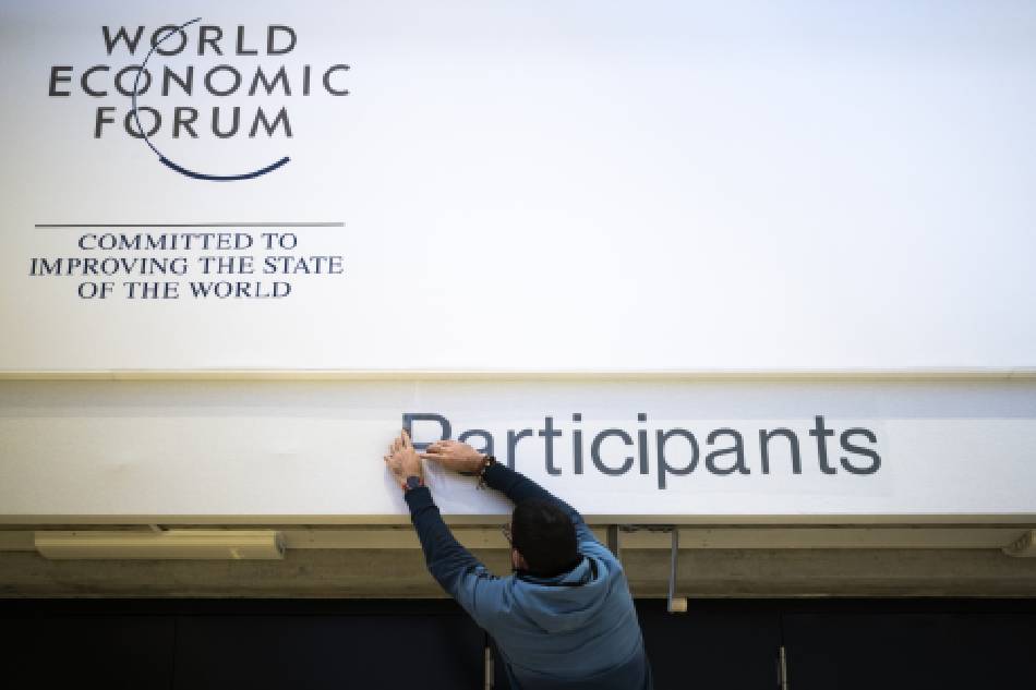 A worker sets the word 'Participants' at the main hall on the eve of the 52nd annual meeting of the World Economic Forum (WEF) in Davos, Switzerland, Jan. 15, 2023. The meeting brings together entrepreneurs, scientists, corporate and political leaders in Davos under the topic 'Cooperation in a Fragmented World' from Jan. 16 to 20. Gian Ehrenzeller, EPA-EFE