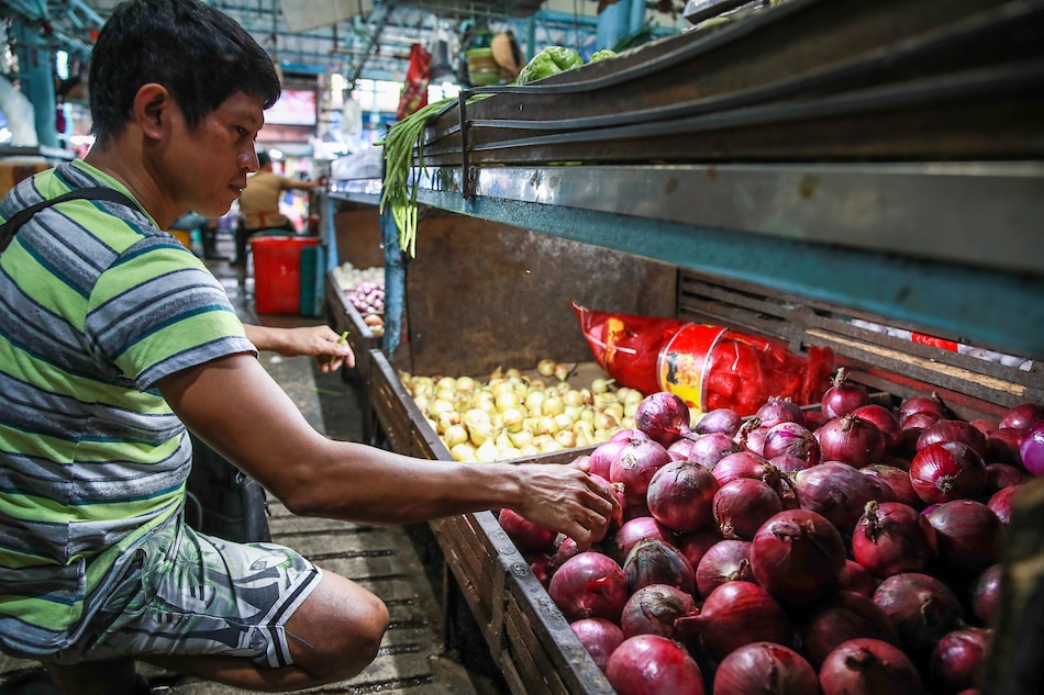 A produce vendor attends to the store’s inventory of both local and imported onions at a public market in Marikina City on Jan. 25, 2023. Jonathan Cellona, ABS-CBN News