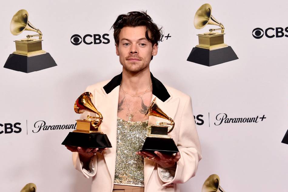 Harry Styles poses with the Best Pop Vocal Album Award for “Harry’s House” and Album of the Year Award for “Harry’s House” in the press room during the 65th Grammy Awards at Crypto.com Arena in Los Angeles, California. Alberto E. Rodriguez, Getty Images for The Recording Academy/AFP