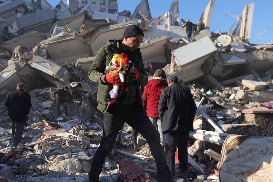 People take belongings from the rubble of a collapsed building in the city of Kahramanmaras, southeastern Turkey, Feb. 8, 2023. More than 11,000 people have died and thousands more are injured after two major earthquakes struck southern Turkey and northern Syria on Feb. 6. Authorities fear the death toll will keep climbing as rescuers look for survivors across the region. Abir Sultan, EPA-EFE