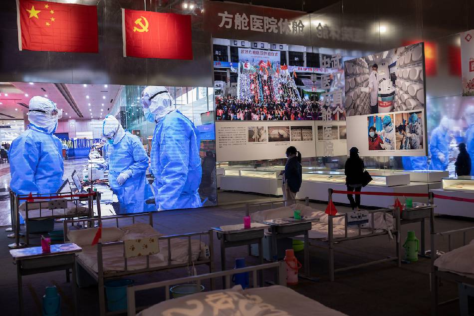 People visit an exhibition about Chinaí fight against the COVID-19 at a convention center that was previously a makeshift hospital for coronavirus patients in Wuhan on Jan. 15, 2021. Nicolas Asfouri, AFP/File 