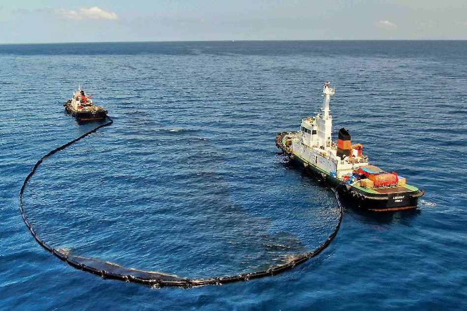 The Philippine Coast Guard deploys an oil spill boom and skimmer with manual scooping around the suspected area of the sunken MT Princess Empress in Oriental Mindoro on March 14, 2023. Photo courtesy of Malayan Towage and Salvage Corporation/Philippine Coast Guard