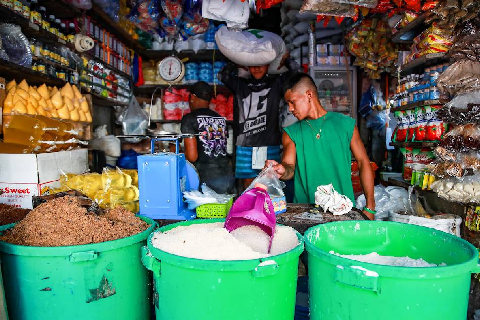 Store workers attend to customers buying sugar at their stall in Bagong Silang public market in North Caloocan on Jan. 19, 2023. Jonathan Cellona, ABS-CBN News/File