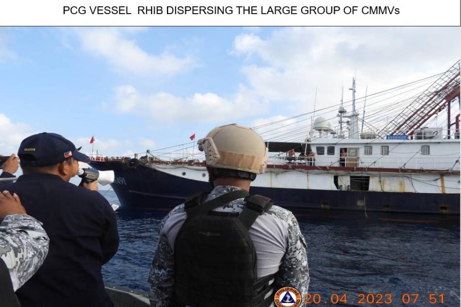 Philippine Coast Guard personnel attempt to disperse a large group of Chinese militia vessels in the West Philippine Sea. Photo from Philippine Coast Guard 