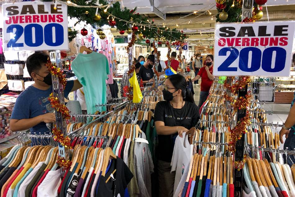 Shoppers sift through overrun clothes for sale inside the Greenhills Shopping Center in San Juan on December 6, 2022. George Calvelo, ABS-CBN News/File