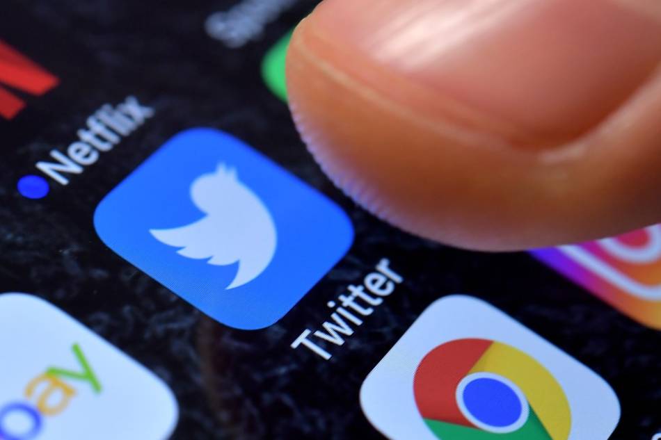 A close-up image showing the Twitter app on an iPhone. Sascha Steinbach, EPAEFE/Illustration/File 
