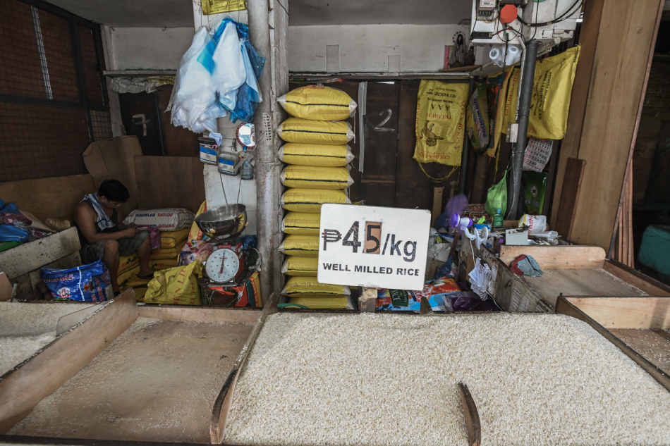 Vendors put up a P45 sign at a box of well-milled rice at the Mega Q-Mart in Quezon City on September 3, 2023, in compliance with the implementation of a price ceiling for regular and well-milled rice in the country. Maria Tan, ABS-CBN News/File
