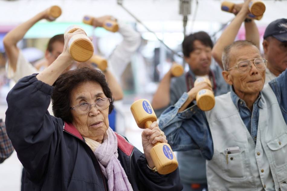 Elderly people practice physical activity with wooden dumbbells during an event marking the 'Respect for the Aged Day' in Tokyo, Japan, Sept. 16, 2019. Franck Robichon, EPA-EFE 