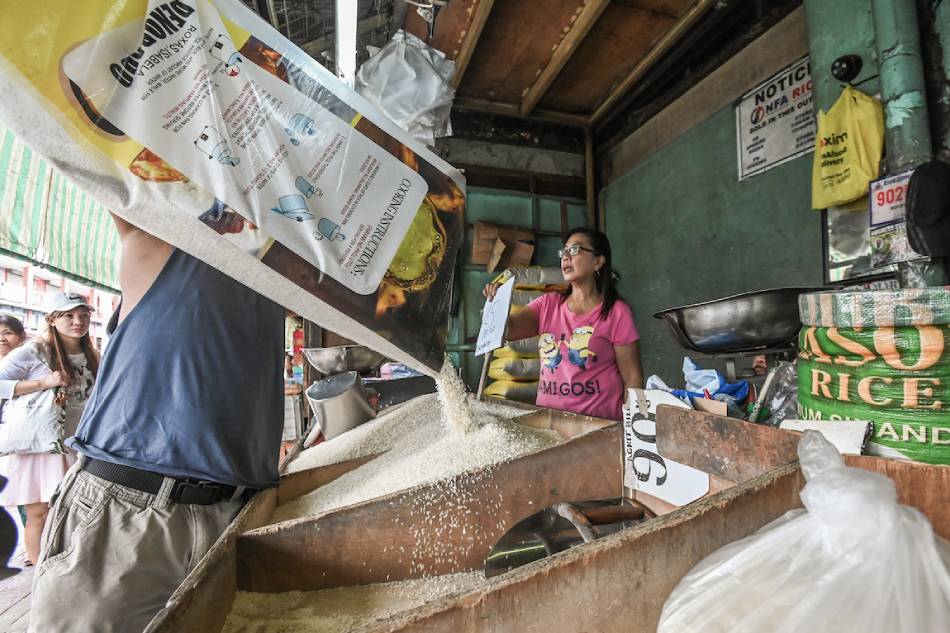 Vendors put up a P45 sign at a box of well-milled rice at the Mega Q-Mart in Quezon City on September 3, 2023, in compliance with the implementation of a price ceiling for regular and well-milled rice in the country. Consumers are allowed to purchase up to five kilograms of well-milled rice per day due to limited supply. Maria Tan, ABS-CBN News