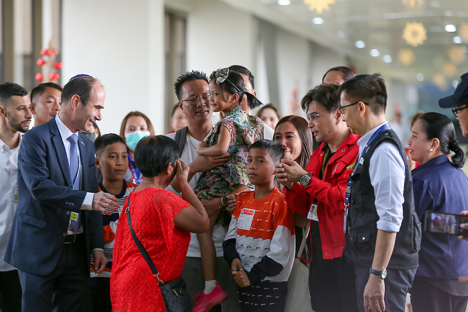 Jimmy Pacheco, a Filipino overseas worker (OFW) caught inside the conflict between Israel and Hamas, hugs his family upon arrival at the Ninoy Aquino International Airport in Pasay City, Manila on December 18, 2023. Pacheco, who was kidnapped from an Israeli Kibbutz on October 7 during the Hamas siege, was freed in Gaza on November 24. Jonathan Cellona, ABS-CBN News