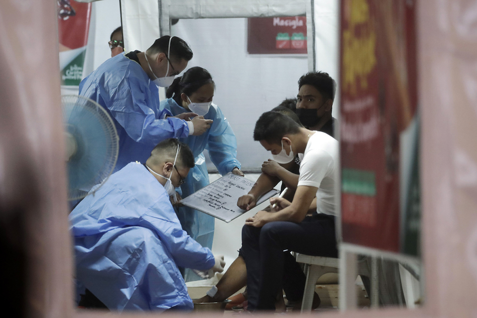 Filipino doctors treat injured revelers at a hospital during New Year