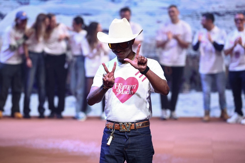 : Designer Pharrell Williams appears at the end of his menswear ready-to-wear Fall-Winter 2024/2025 collection show for fashion house Louis Vuitton during Men's Fashion Week in Paris, France. Stephanie Lecocq, Reuters