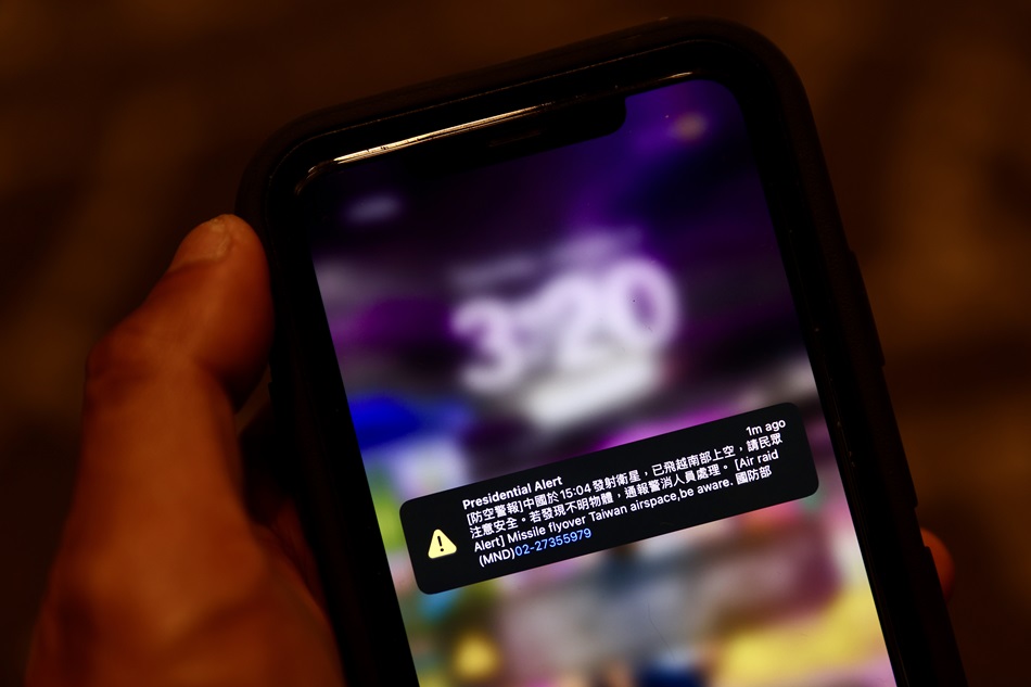 A lost in translation emergency alert pop-up on a mobile phone is seen during the press conference of Taiwan