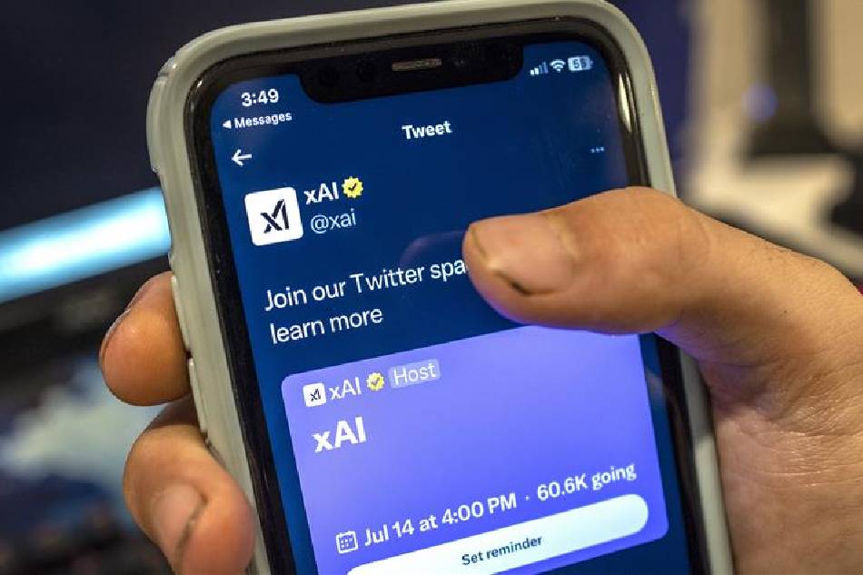 A person waits to listen to the Twitter Spaces chat of the xAI team on a cell phone in Miami, Florida, USA, July 14, 2023. On July 12, 2023, entrepreneur Elon Musk launched his artificial intelligence startup xAI, after months of teasing plans to build a rival to ChatGPT. Cristobal Herrera-Ulashkevich, EPA-EFE/File.