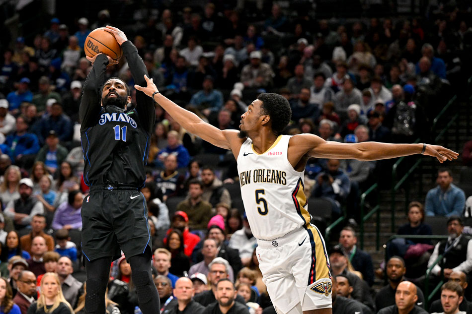 Dallas Mavericks guard Kyrie Irving (11) shoots the ball over New Orleans Pelicans forward Herbert Jones (5) during the second quarter at the American Airlines Center. Mandatory Credit: Jerome Miron-USA TODAY Sports