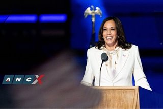 Kamala Harris in a white suit, dressing for history