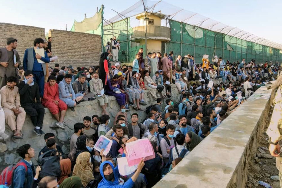 Crowds wait outside the airport in Kabul, Afghanistan