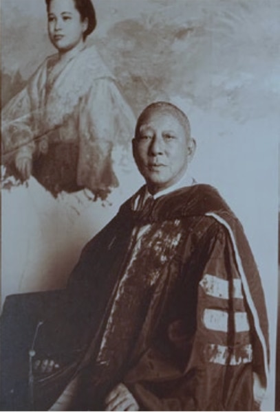 Photograph of an unidentified client of Amorsolo with the half-done portrait behind him.