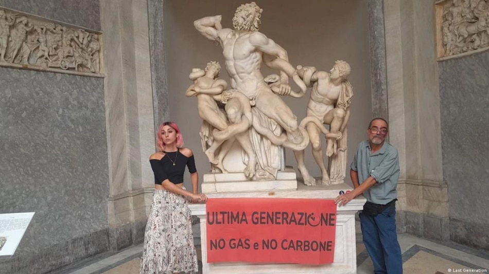 'Last Generation: No gas, No Coal' reads a banner held by climate activists who glued their hands to a Vatican statue