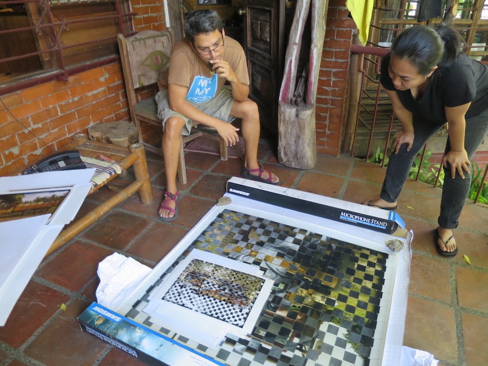 Looking at one of his woven photographs, with artist Nona Garcia.