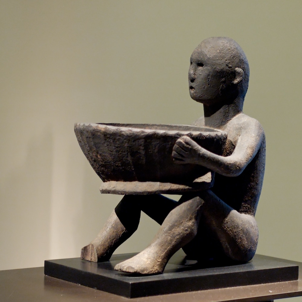 15th century bulul with a pamahan (ceremonial bowl) in the Louvre Museum