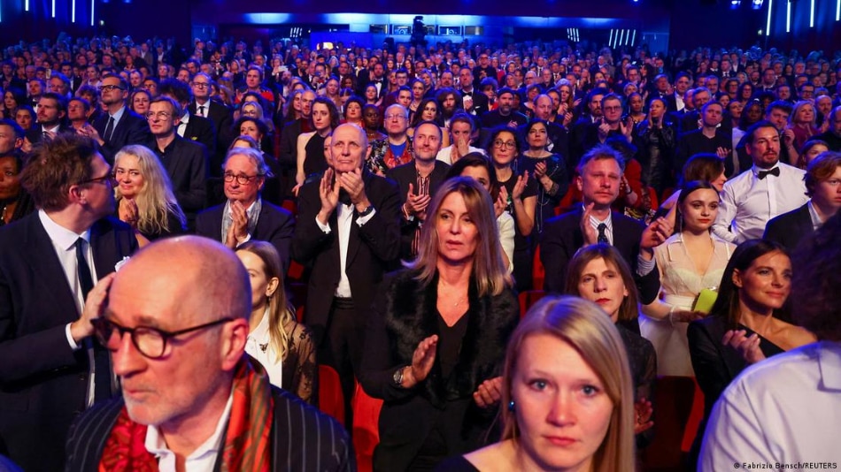 The audience at the opening ceremony giving a standing ovation to the Ukrainian leader