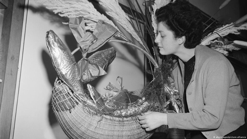 A 1952 picture of a woman handling a basket of chocolate 'April fish'