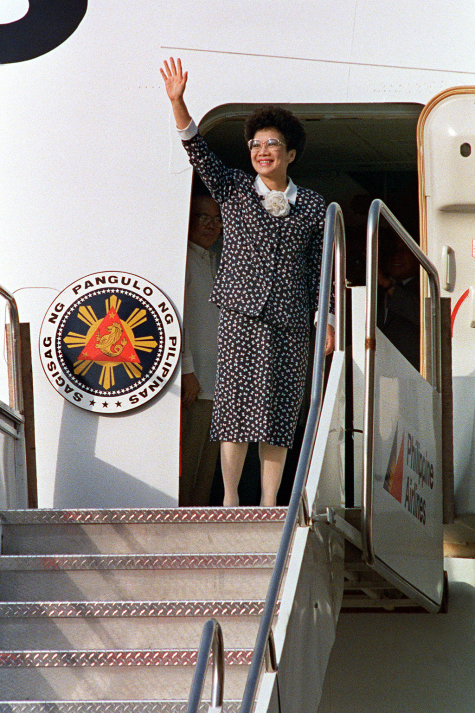 President Aquino bids farewell before boarding a PAL flight in Manila on June 13, 1988